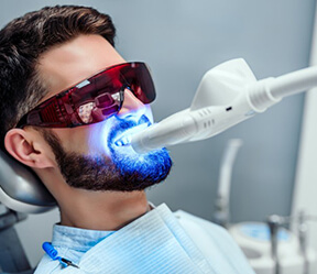 a patient undergoing in-office teeth whitening treatment