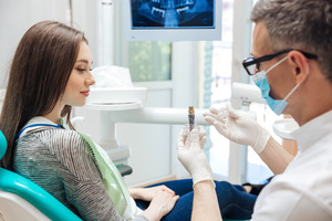 dentist talking to someone about dental implants